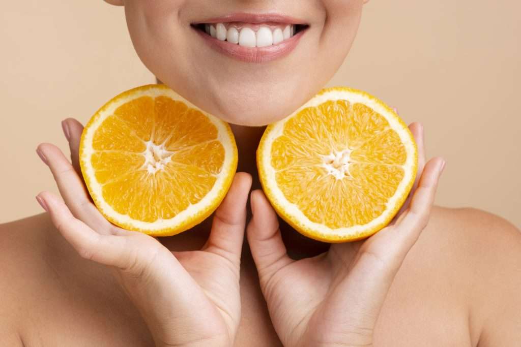 close-up-asian-woman-with-wide-smile-orange-1024×683