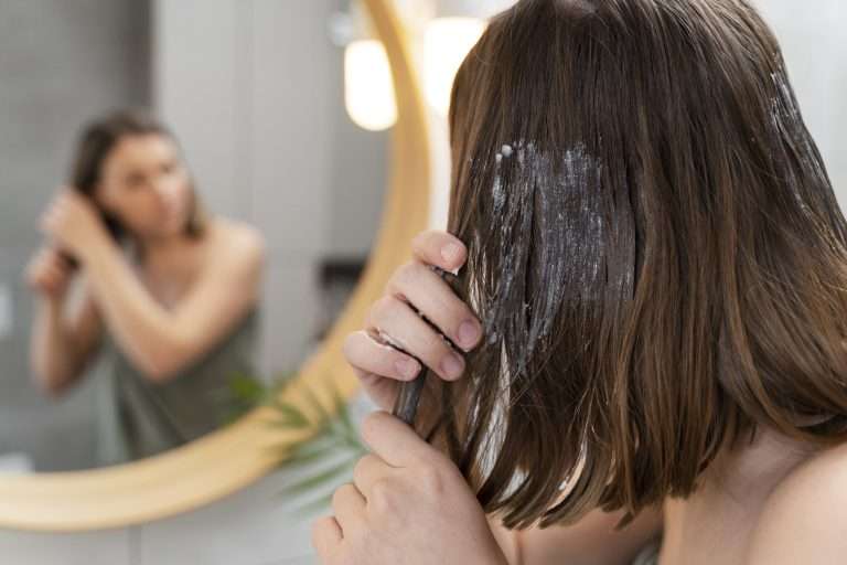 young-woman-applying-anti-dandruff-product-768×512